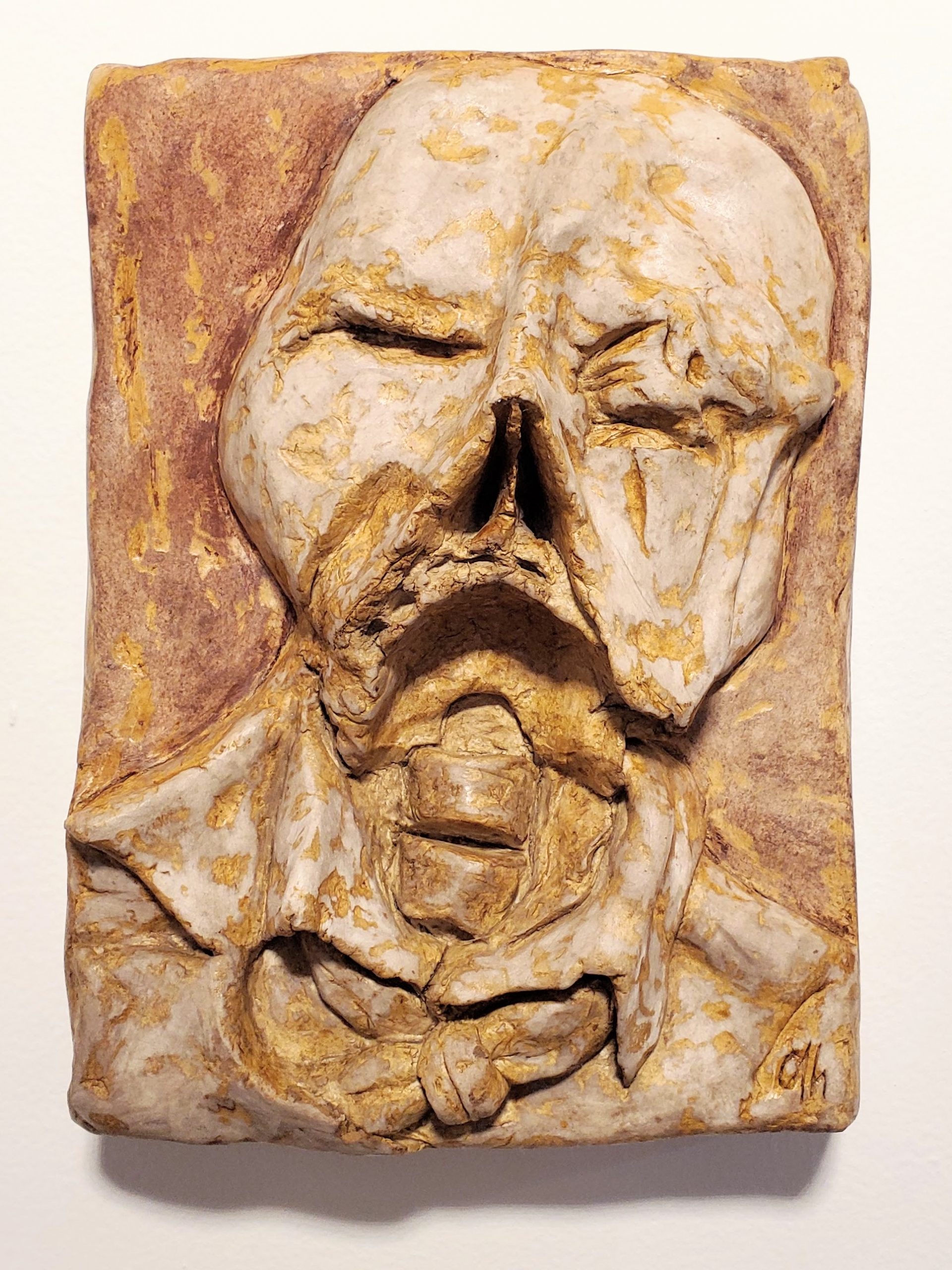 relief sculpture of decomposing businessman, partially mummified, exposed skeleton wearing a suit